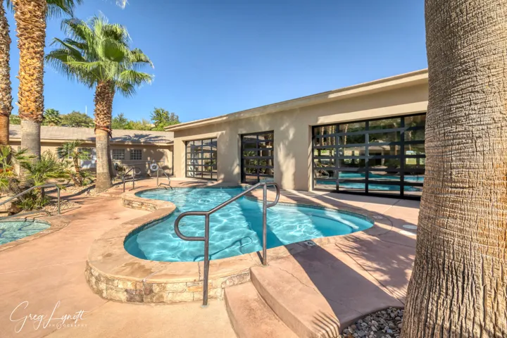Community pool with a patio and a community hot tub