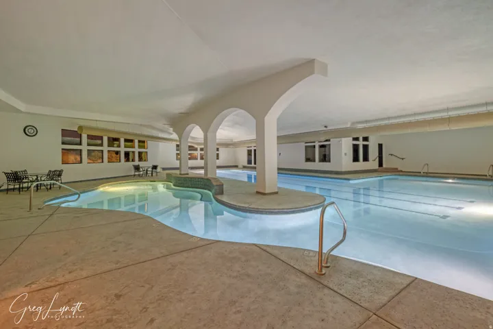 Indoor community pool with a patio area