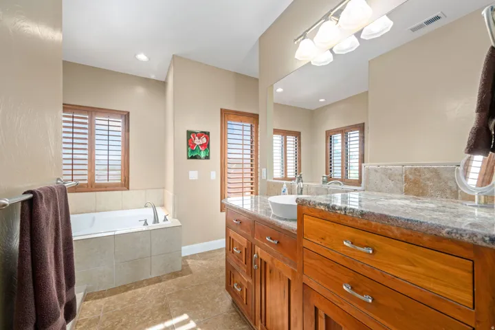 Full bathroom with vanity, a garden tub, light tile patterned flooring, and recessed lighting