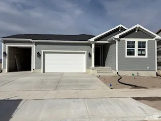 View of front of home featuring an attached garage and driveway