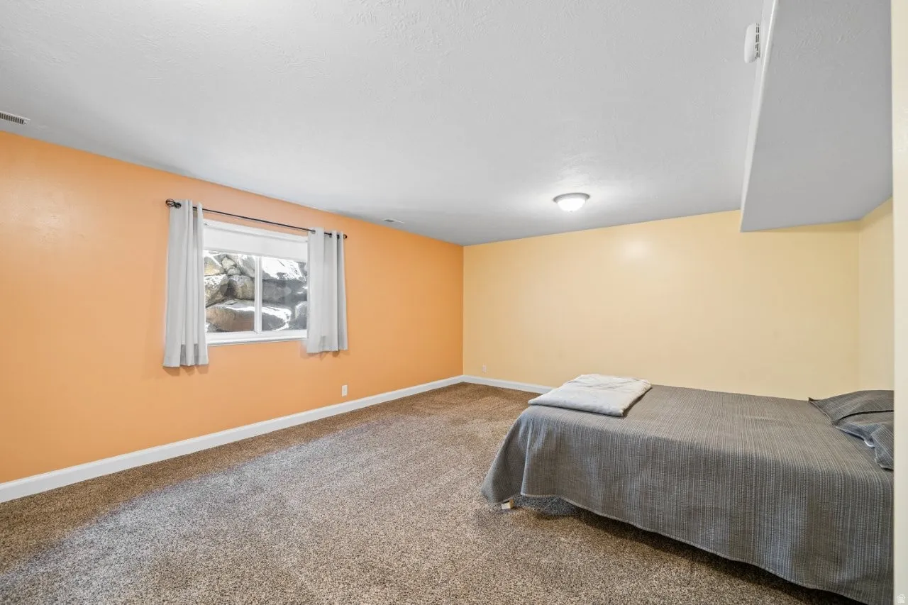 Carpeted bedroom with baseboards