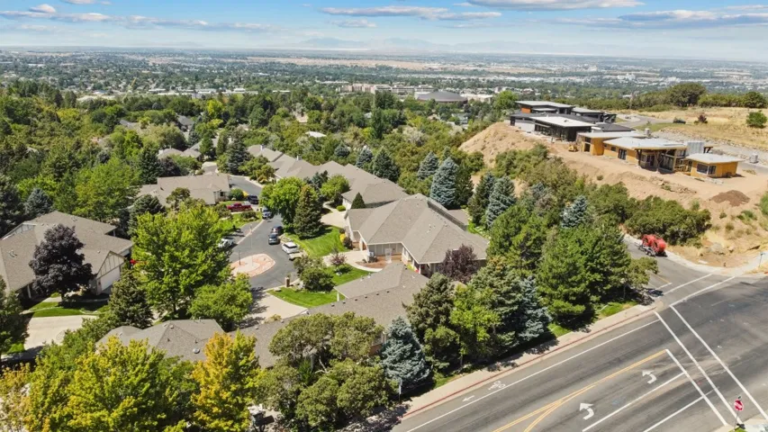 Aerial view of property and surrounding area with nearby suburban area