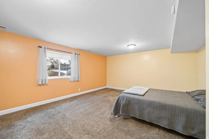 Carpeted bedroom with baseboards