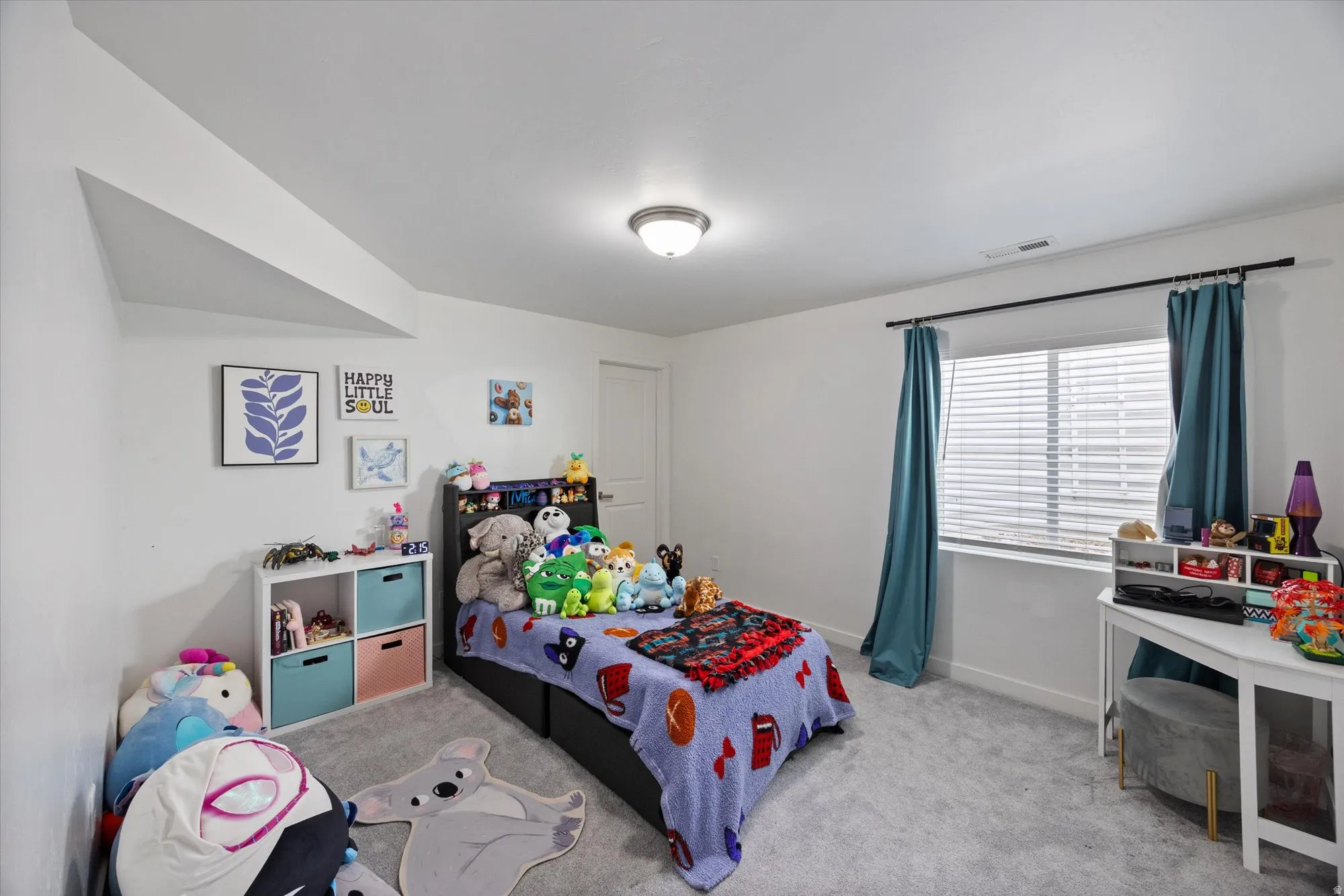 Bedroom with light colored carpet and baseboards