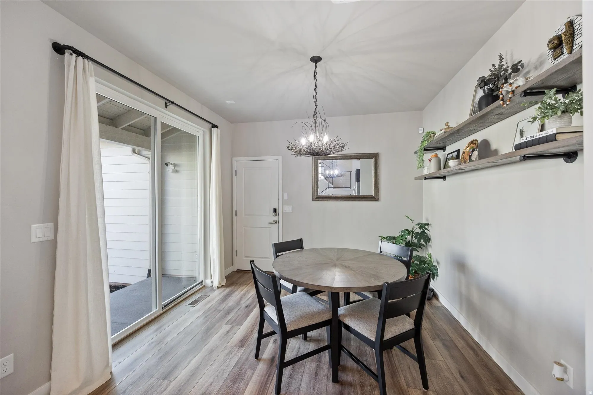 Dining space featuring a chandelier and light wood-style flooring