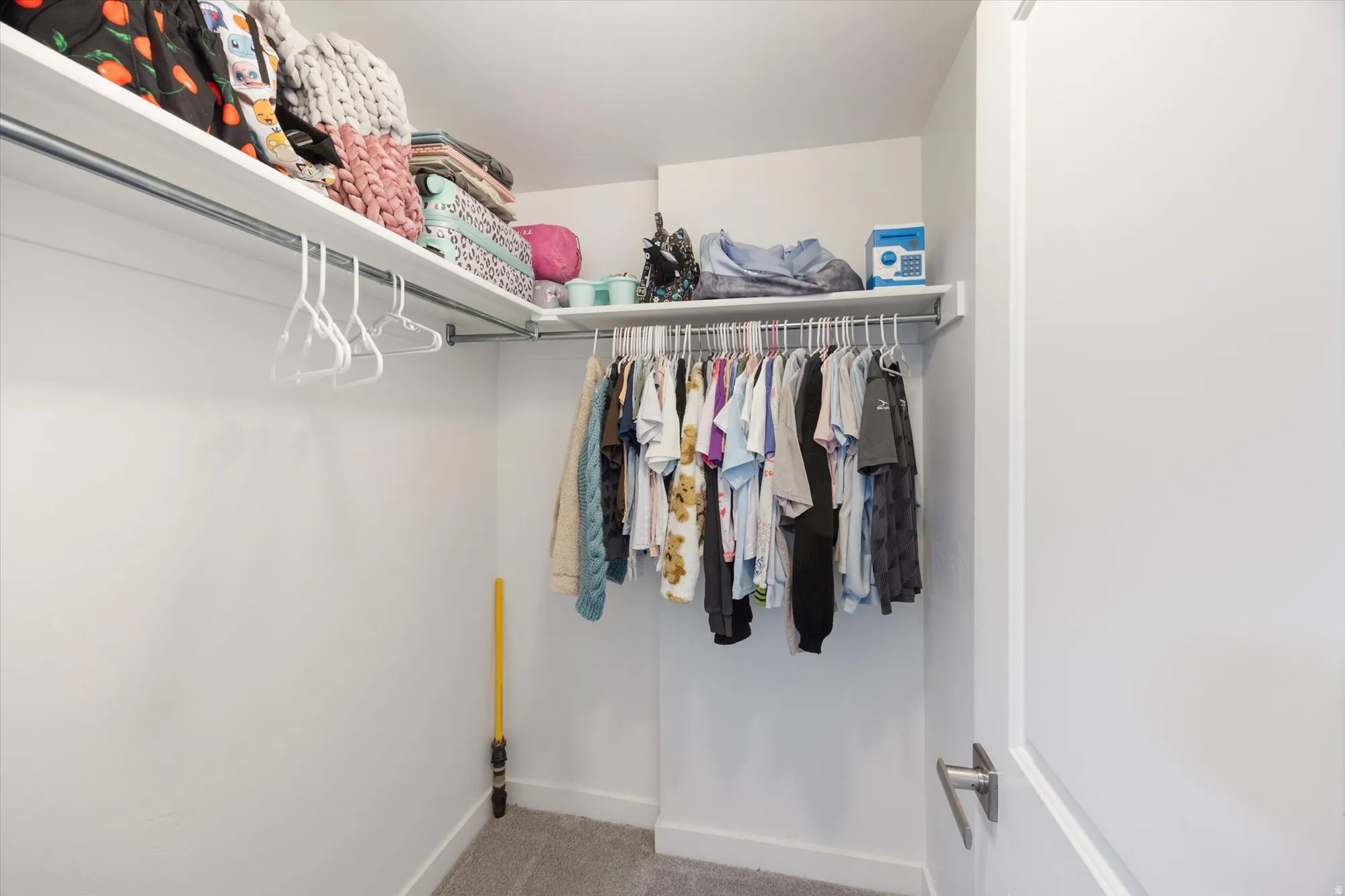 Walk in closet with carpet floors