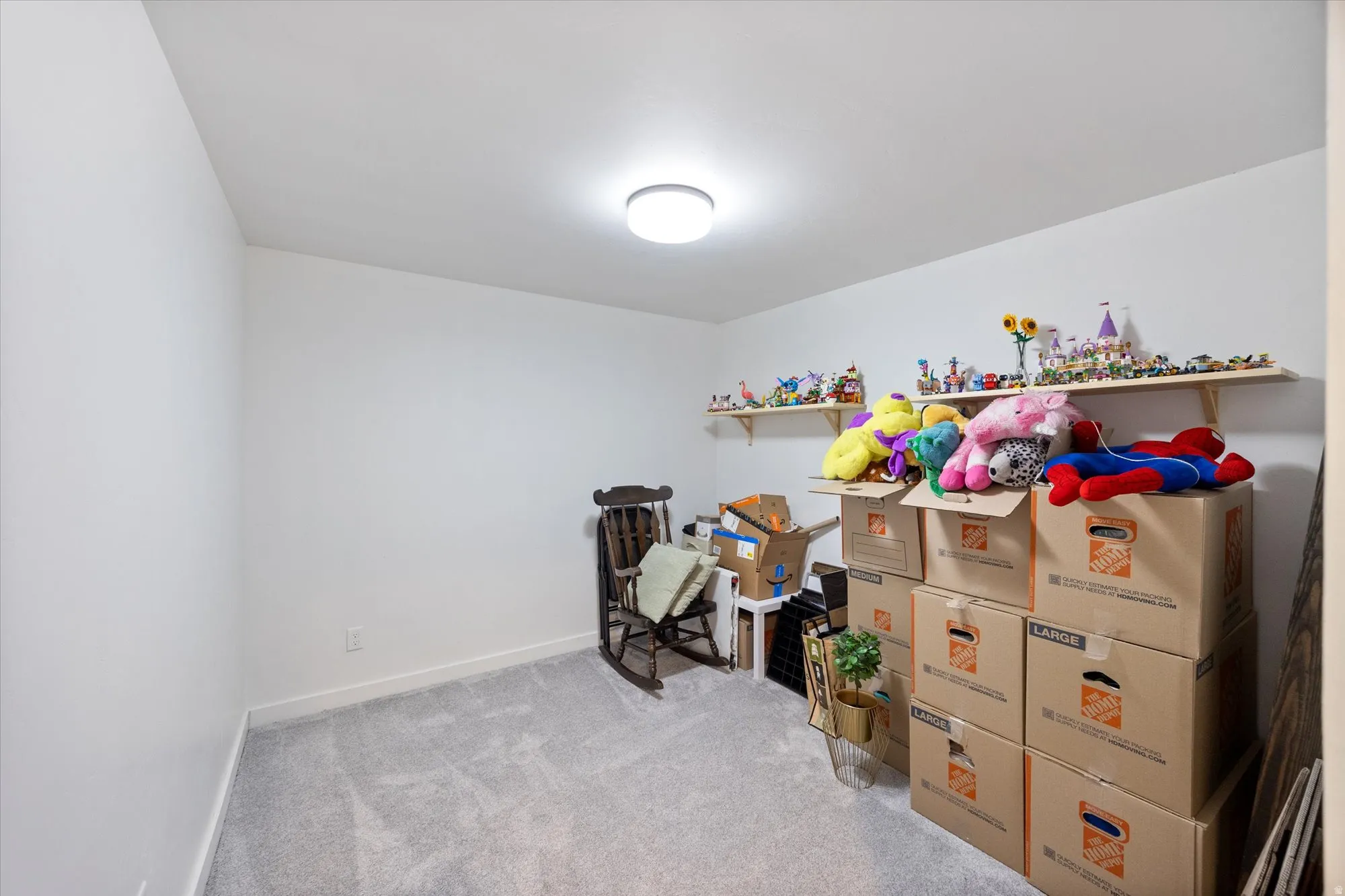 Bedroom featuring light colored carpet and baseboards