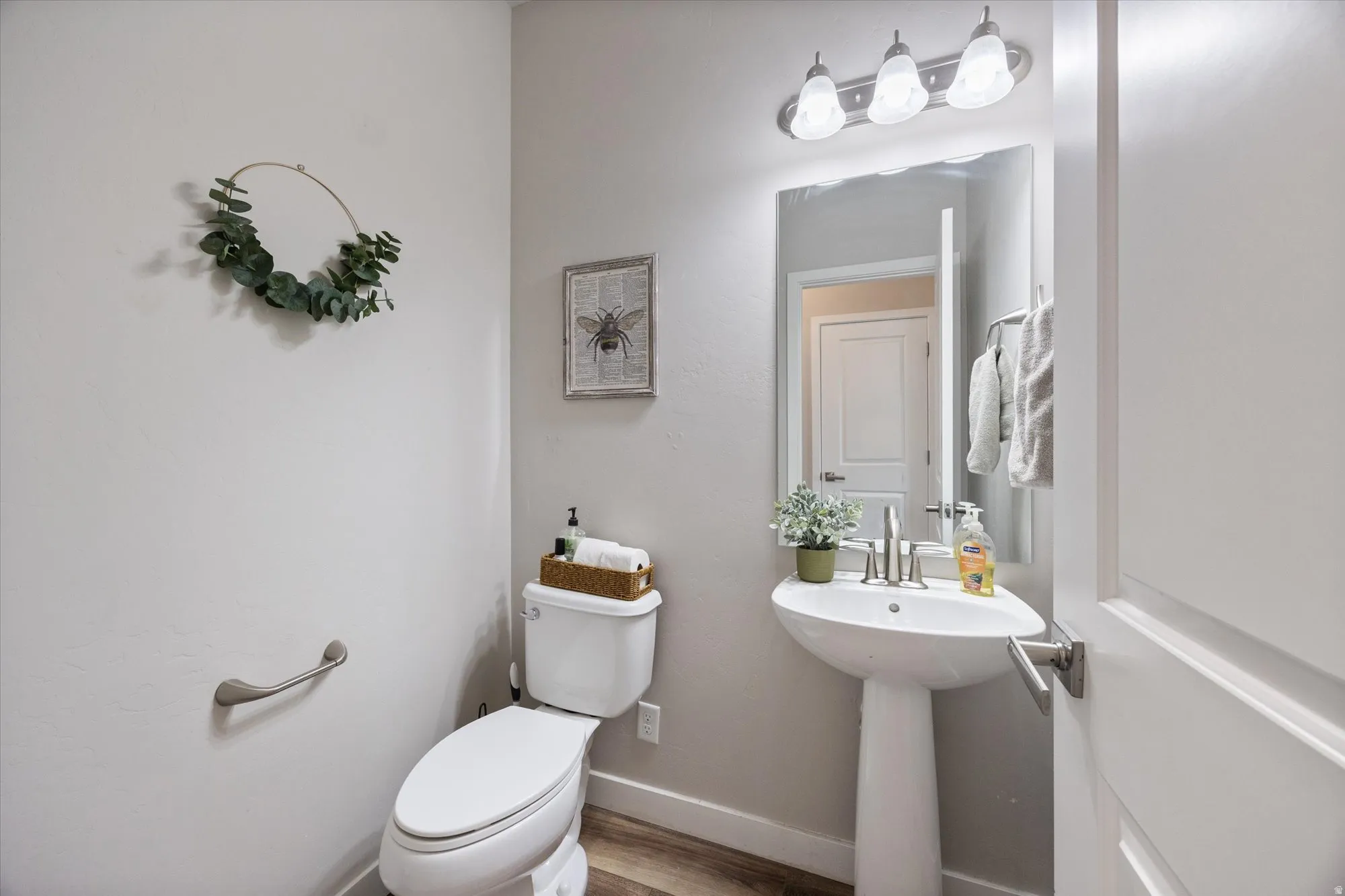 Bathroom with toilet and wood finished floors