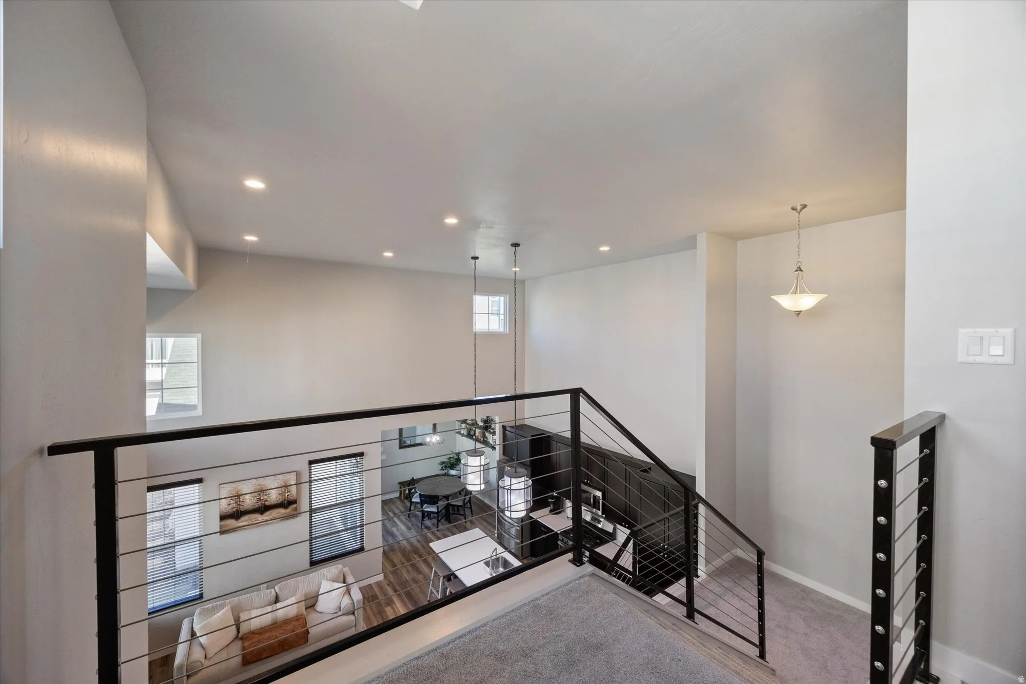 Corridor with carpet floors, recessed lighting, and an upstairs landing