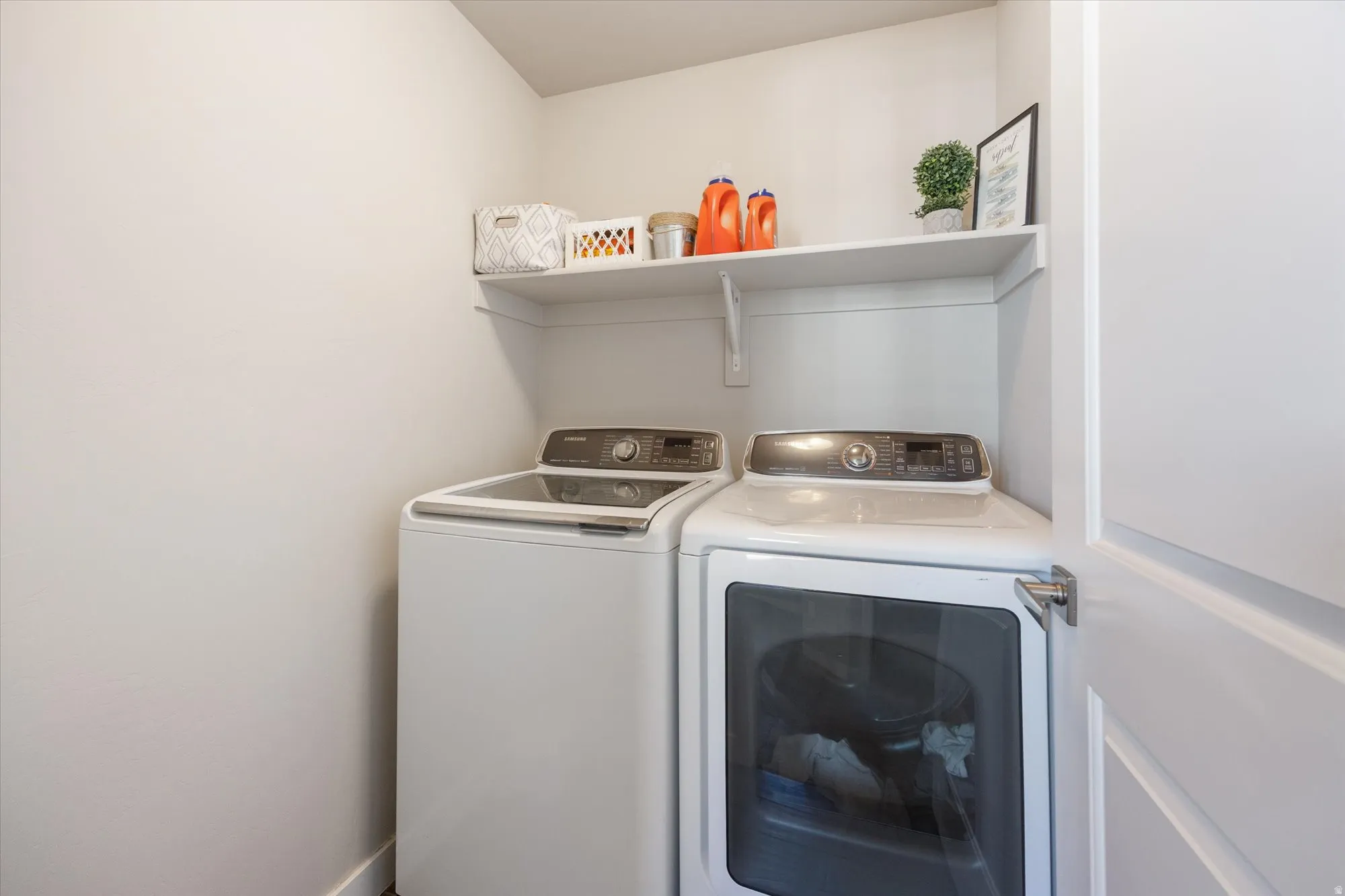 Laundry area featuring washing machine and clothes dryer