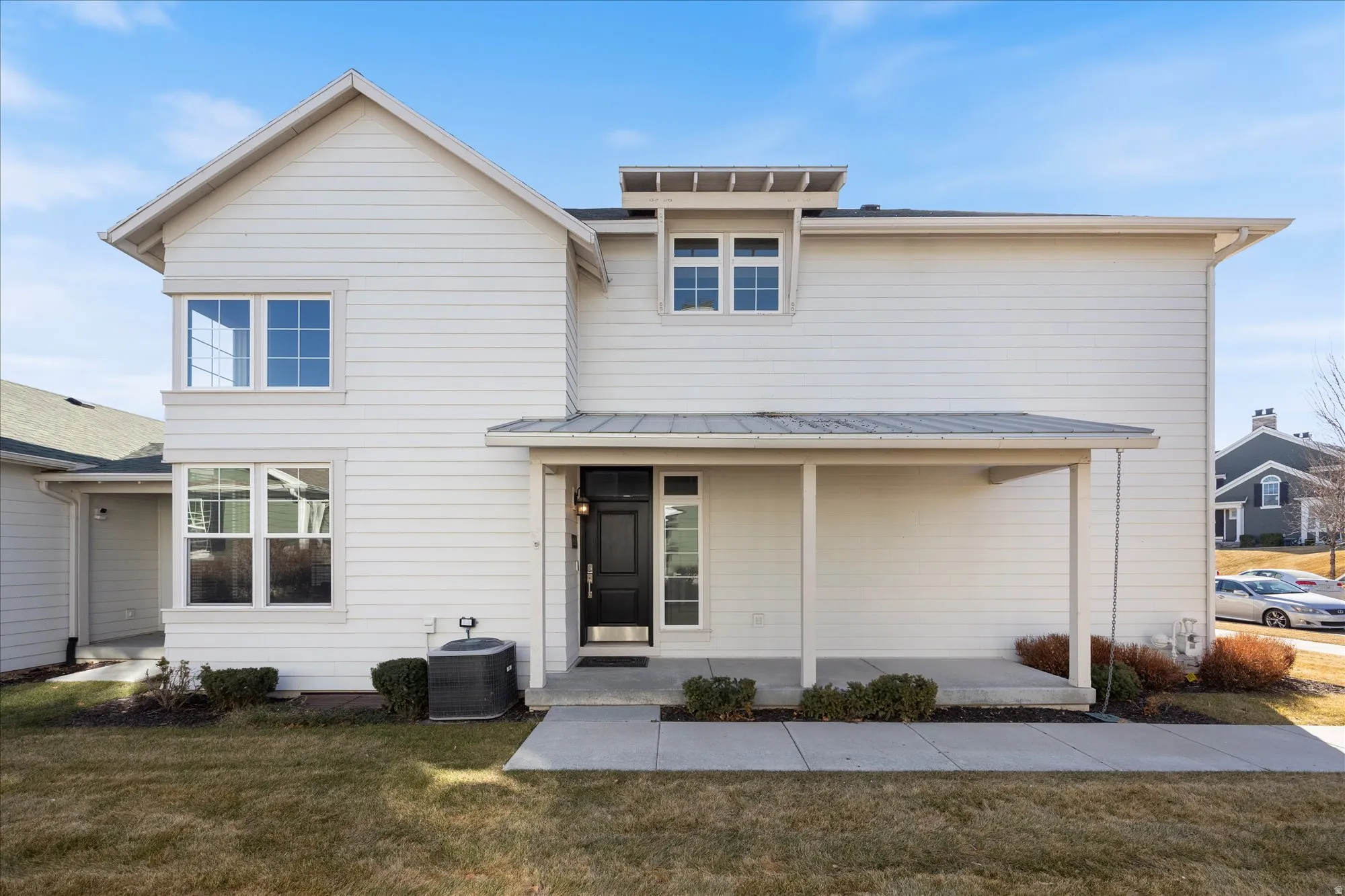 View of front of home with a front yard and covered porch