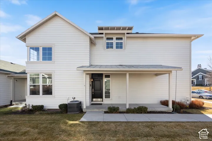 View of front of home with a front yard and covered porch