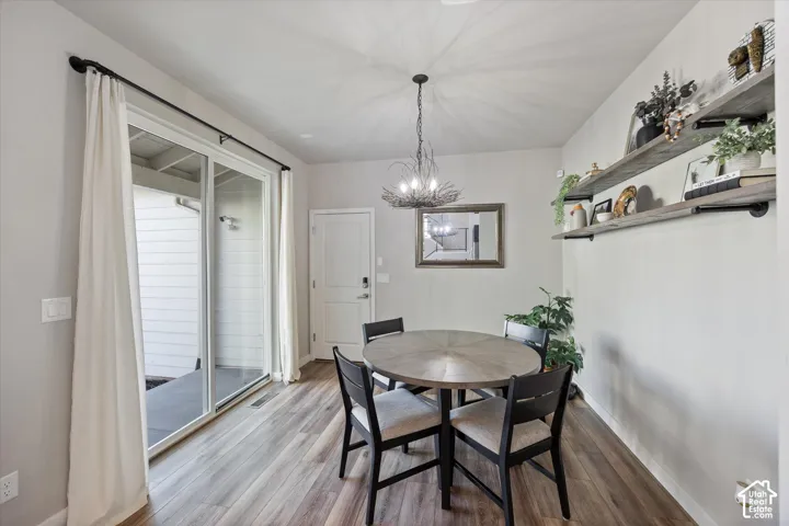 Dining space featuring a chandelier and light wood-style flooring