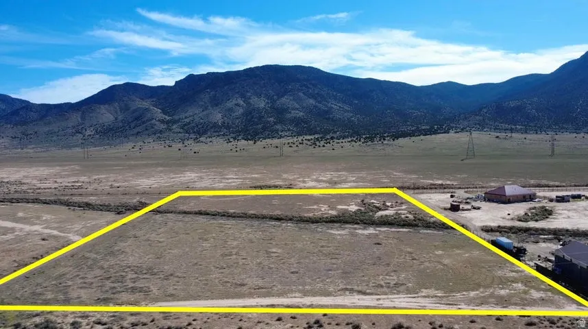 View of rural area featuring a mountainous background and property parcel outlined