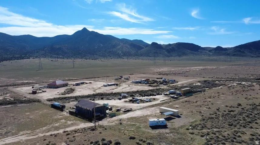 Aerial view of sparsely populated area featuring a mountainous background and a desert landscape