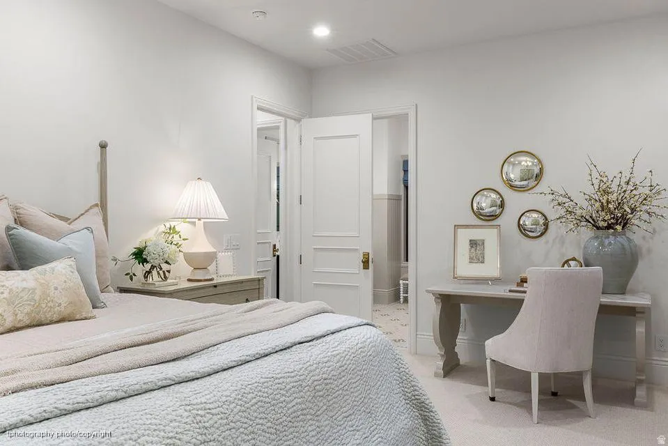 Bedroom featuring light carpet, recessed lighting, and a desk
