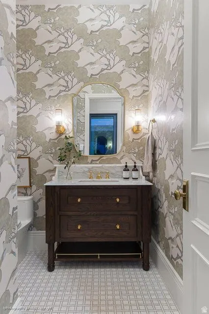 Bathroom with vanity and wallpapered walls