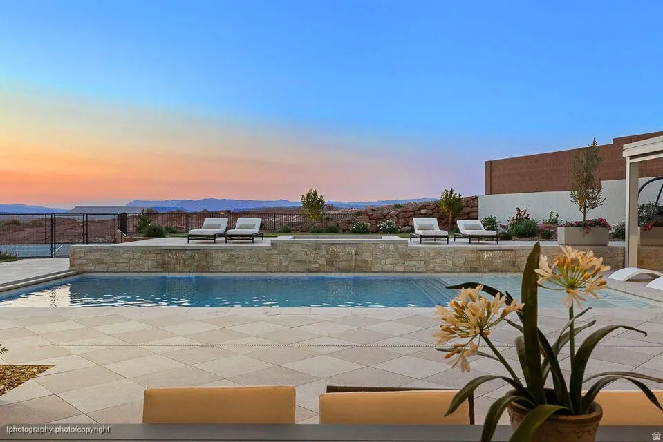 Outdoor pool featuring a patio area and a mountain view