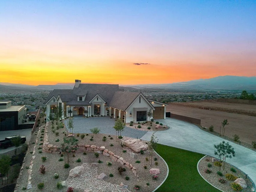 View of front of house with a porch, a chimney, and concrete driveway