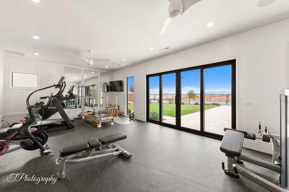 Gym featuring ceiling fan, rubber floors, and recessed lighting