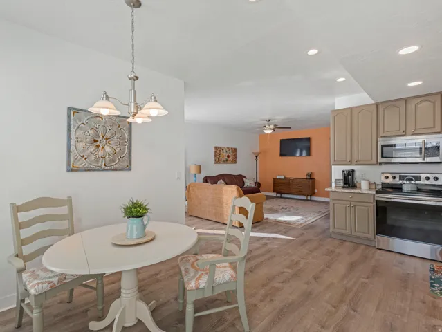 Dining room featuring light wood-style floors, ceiling fan, and hanging lights