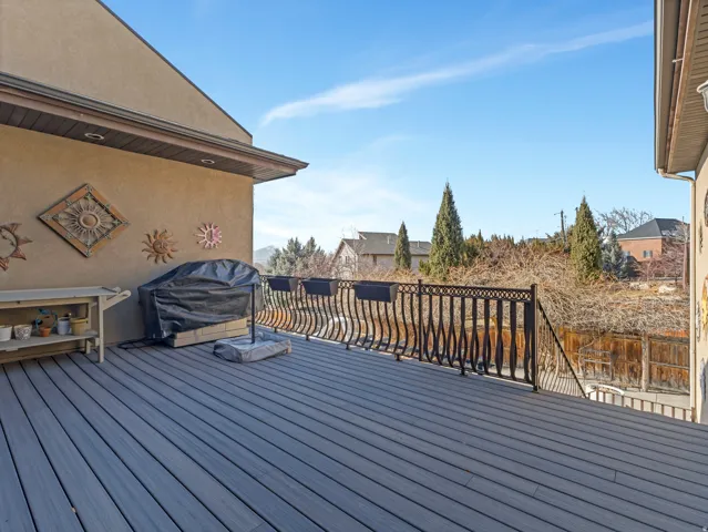 Wooden deck featuring area for grilling