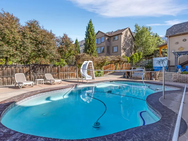 Outdoor swimming pool with stamped concrete coping and light blue interior finish