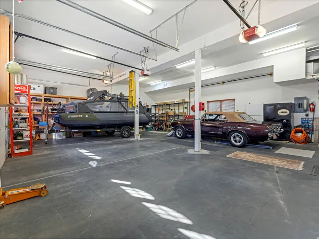 Garage featuring electric panel and a garage door opener
