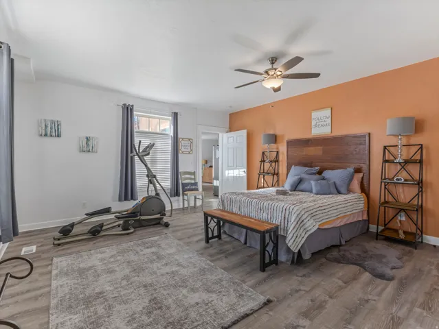Bedroom with light wood finished floors and ceiling fan