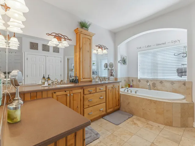 Full bathroom with double vanity and a garden tub