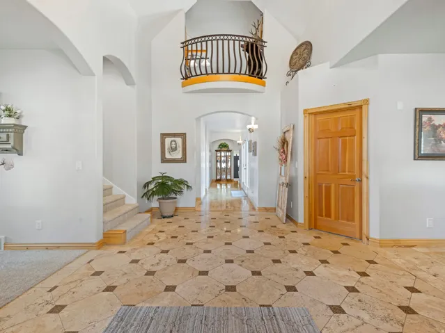 Foyer entrance with arched walkways and a high ceiling