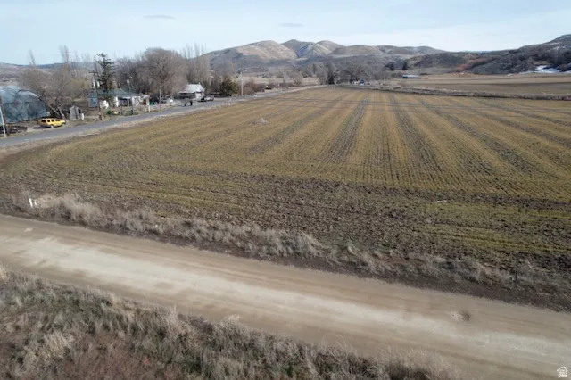 Aerial view of sparsely populated area with extensive farmland and a mountain backdrop