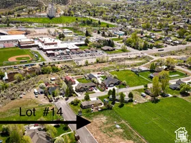 Aerial overview of property's location with a mountain backdrop and nearby suburban area