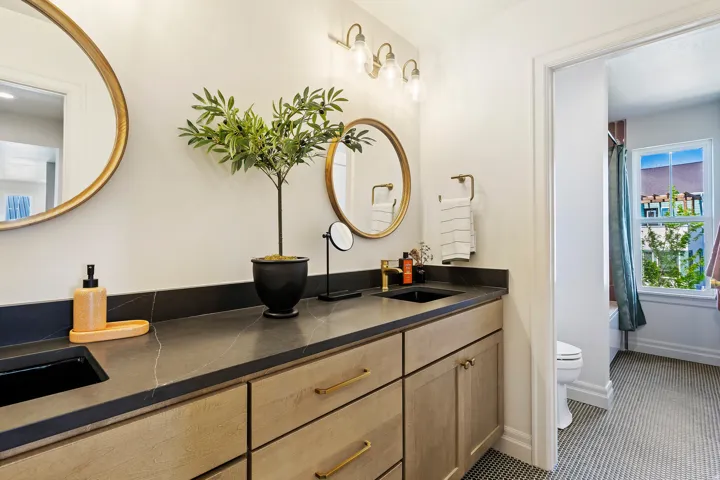 Bathroom featuring double vanity and shower / bath combo with shower curtain
