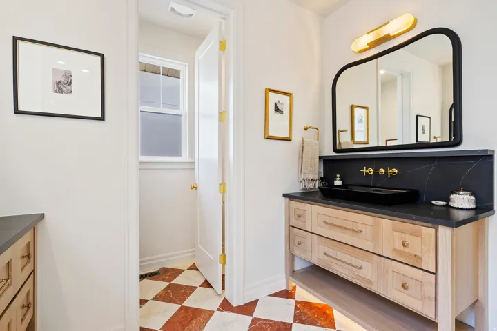 Bathroom with vanity and decorative backsplash