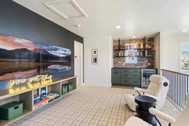Sitting room featuring wine cooler, a textured ceiling, brick wall, a bar, and recessed lighting