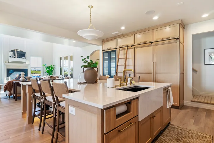 Kitchen featuring open floor plan, light wood finish cabinets, light wood-type flooring, and a large island