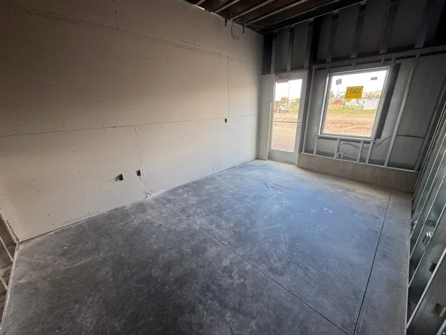 Unfurnished room featuring concrete flooring