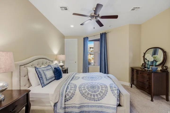 Bedroom featuring carpet flooring, ceiling fan, and vaulted ceiling