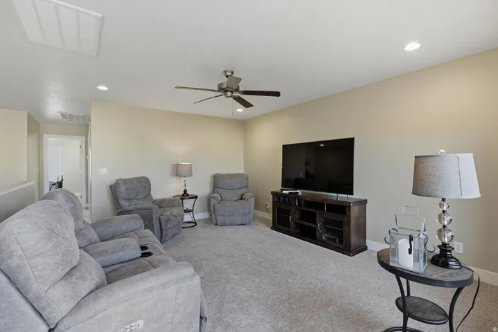 Living room featuring carpet, recessed lighting, and a ceiling fan