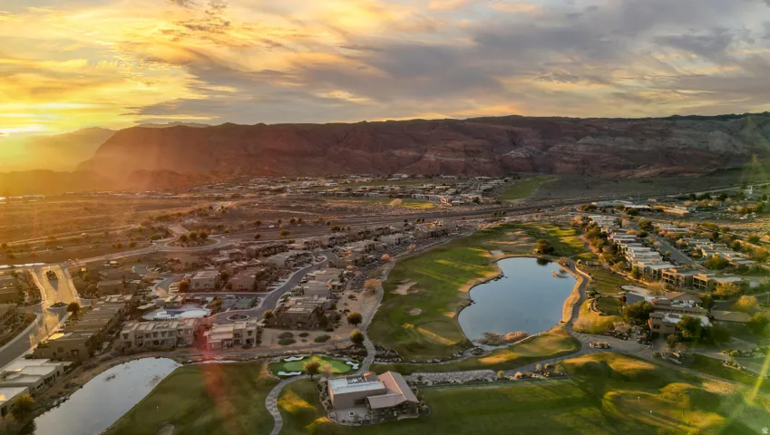 Aerial view at dusk of a water and mountain view, view of golf course, and a residential view