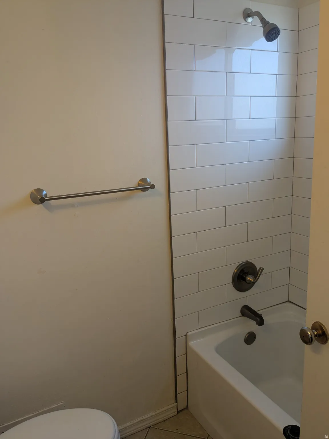 Bathroom featuring shower / bathtub combination and light tile patterned flooring