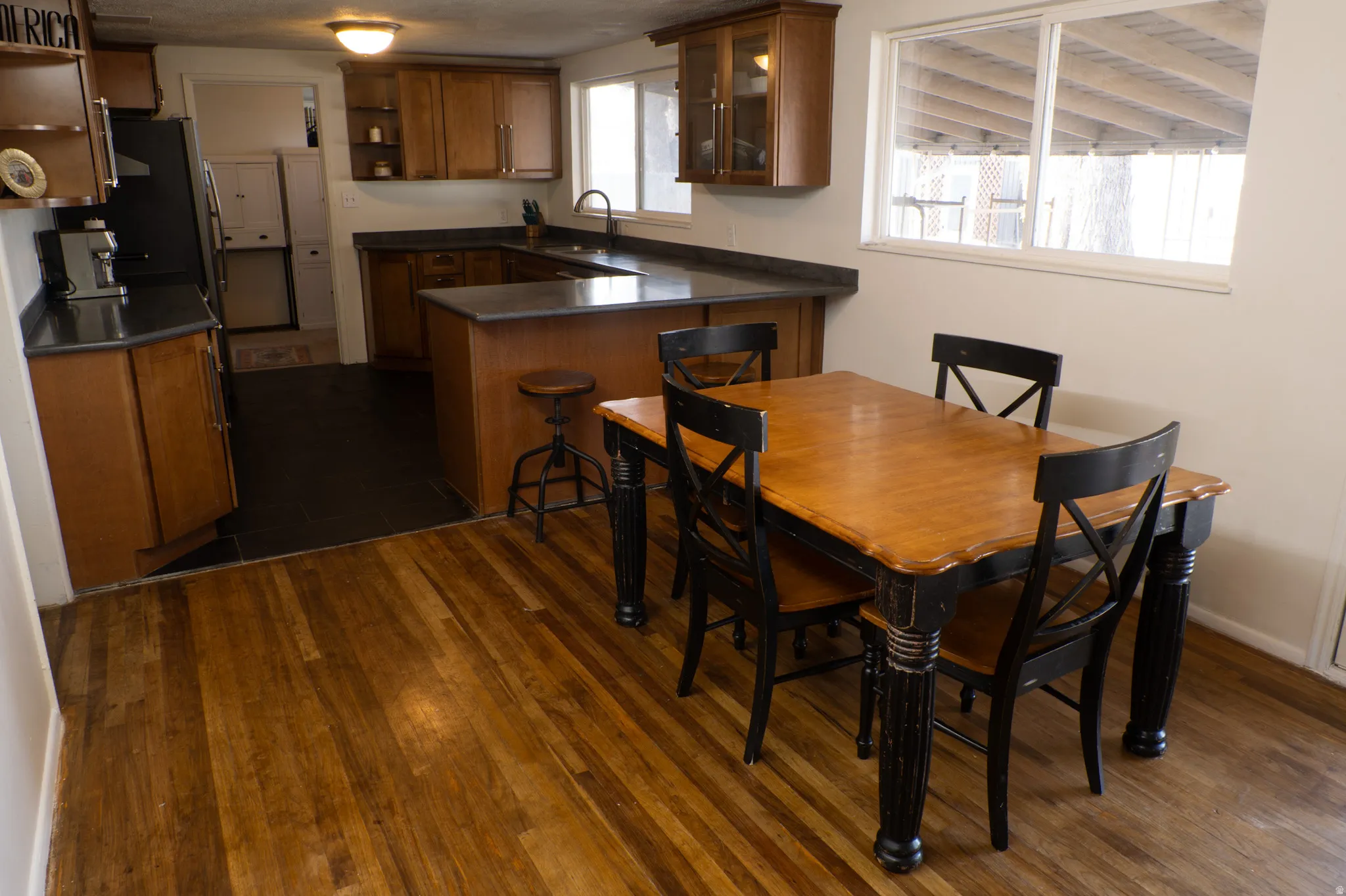 Dining area featuring dark wood-style flooring