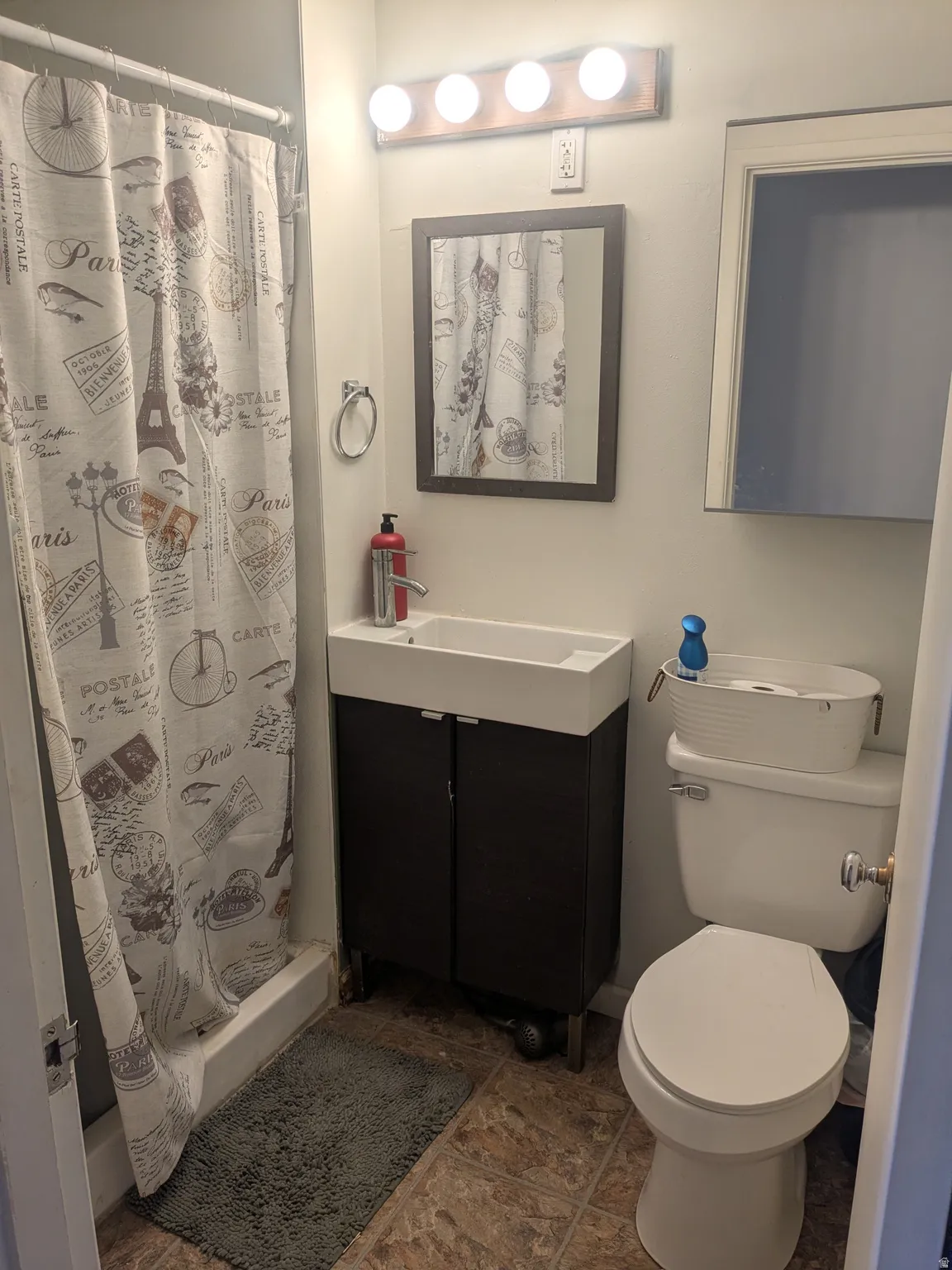 Full bath featuring a stall shower and vanity