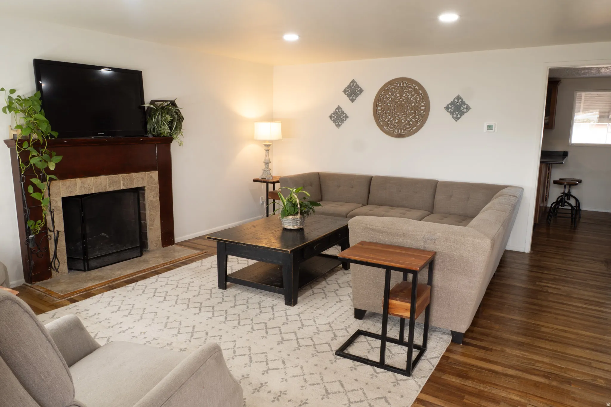Living area featuring wood finished floors, a fireplace, and recessed lighting
