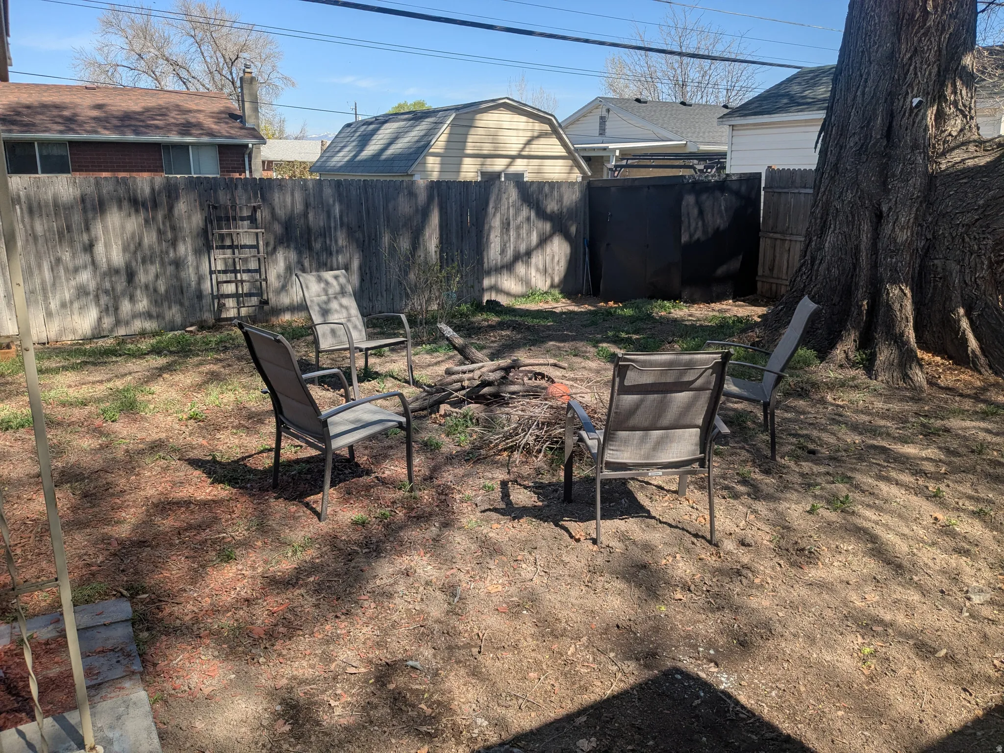 Fenced backyard featuring an outdoor fire pit