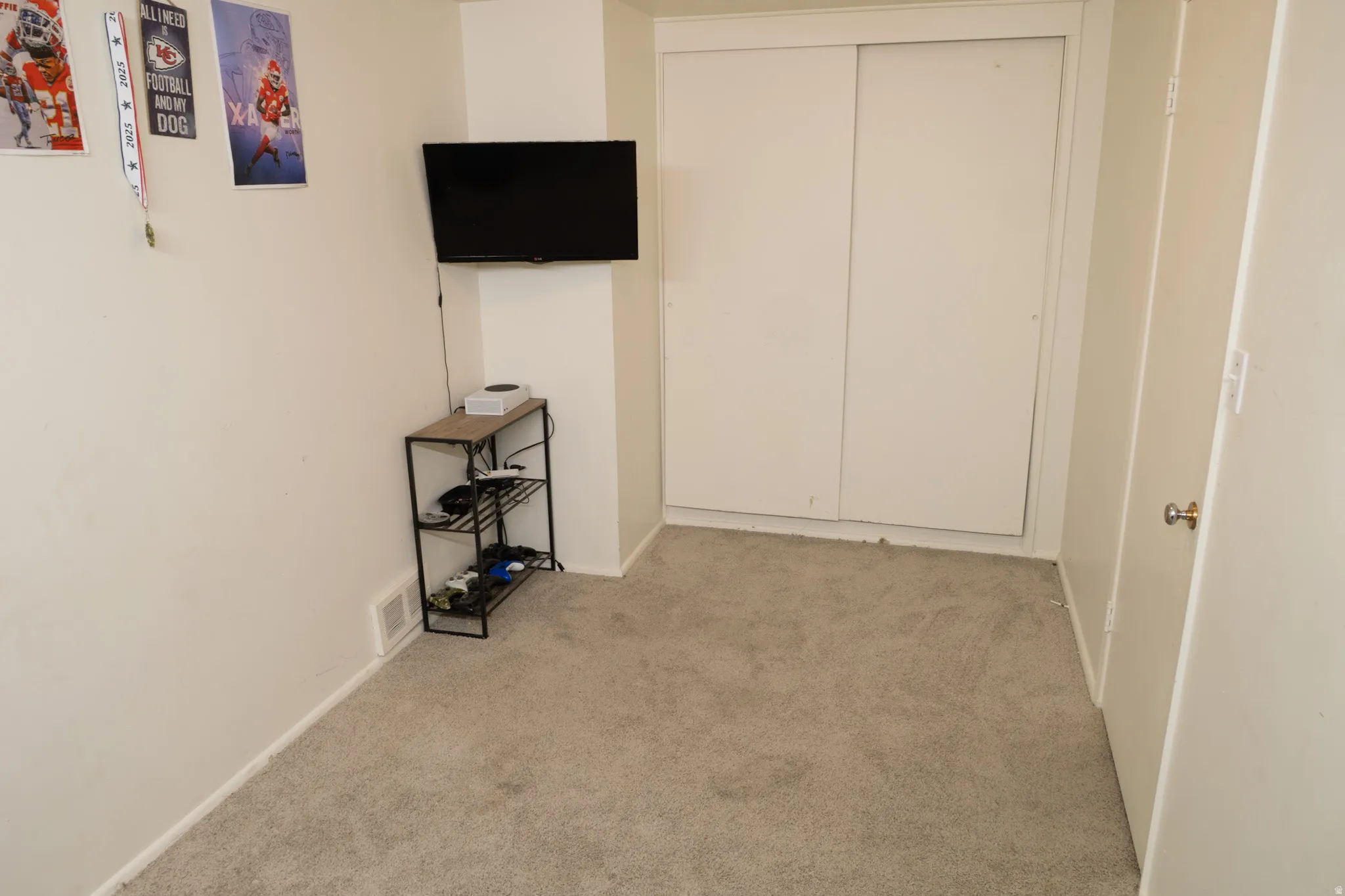 Unfurnished bedroom featuring light carpet and a closet