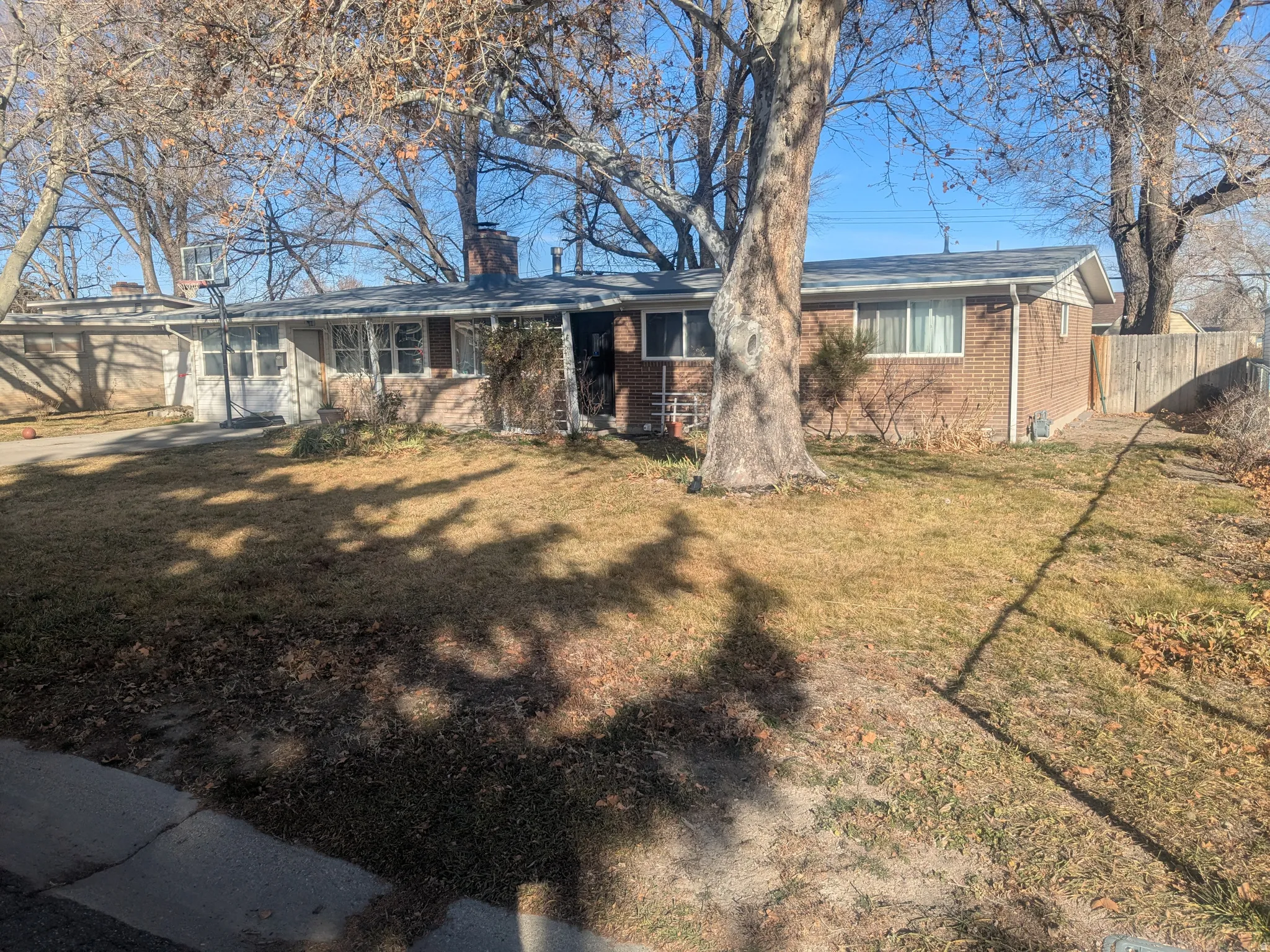 View of front of home with brick siding and a chimney