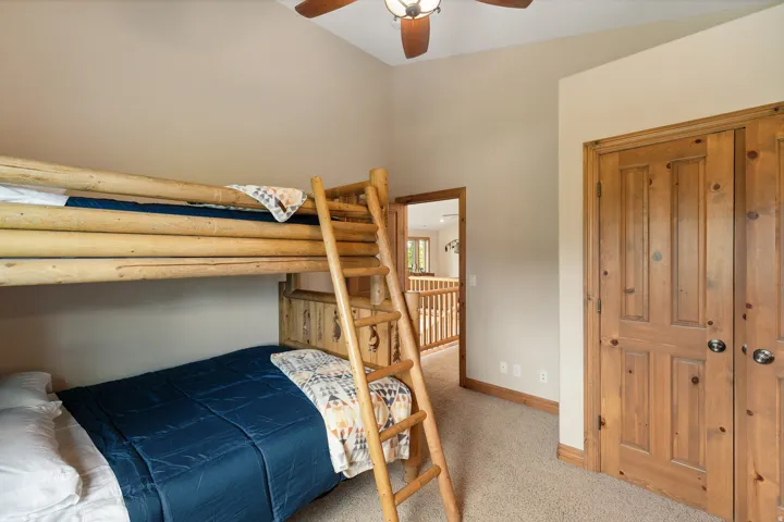 Bedroom featuring light carpet and a ceiling fan
