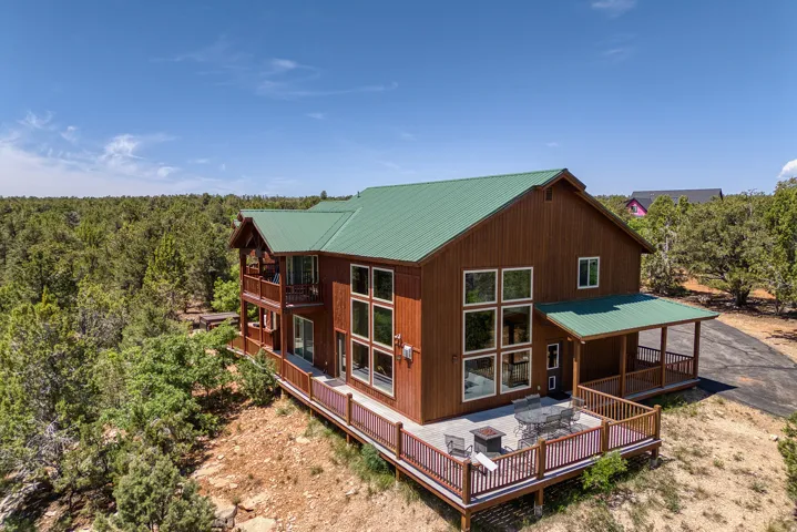 Rear view of property with a metal roof and a deck